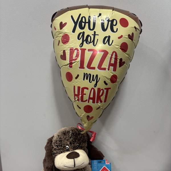 Pizza-shaped balloon above a plush dog holding a Domino's gift card