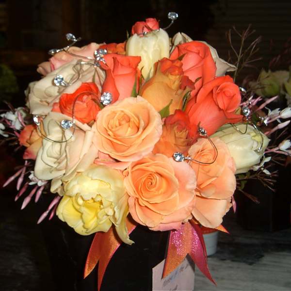 Bouquet of peach and coral roses with decorative crystal picks