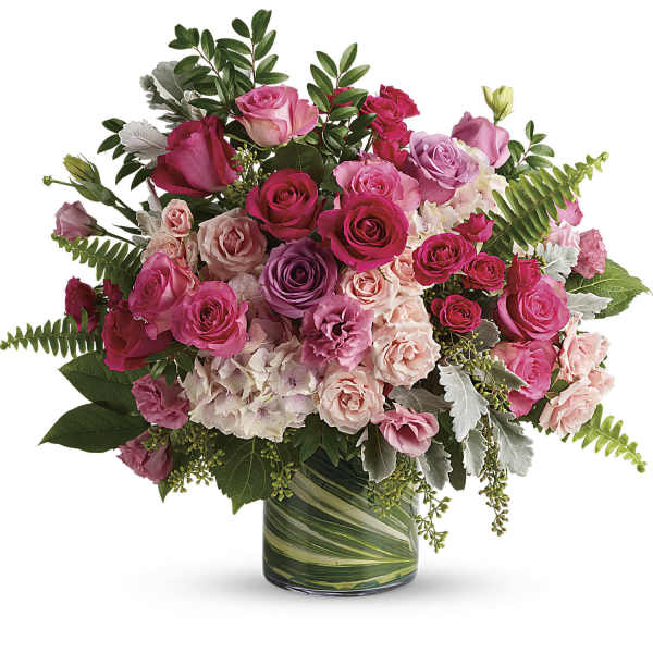 Pink and purple rose bouquet in a glass vase