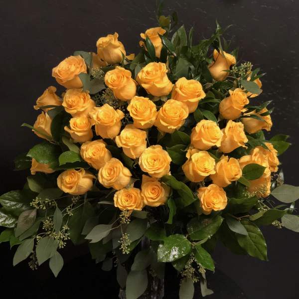 Bouquet of yellow roses in a glass vase
