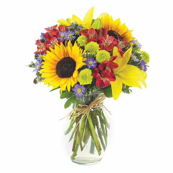 Bouquet of sunflowers, lilies, and mixed blooms in a glass vase