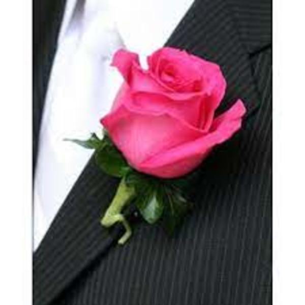 Pink rose boutonniere on a black suit lapel