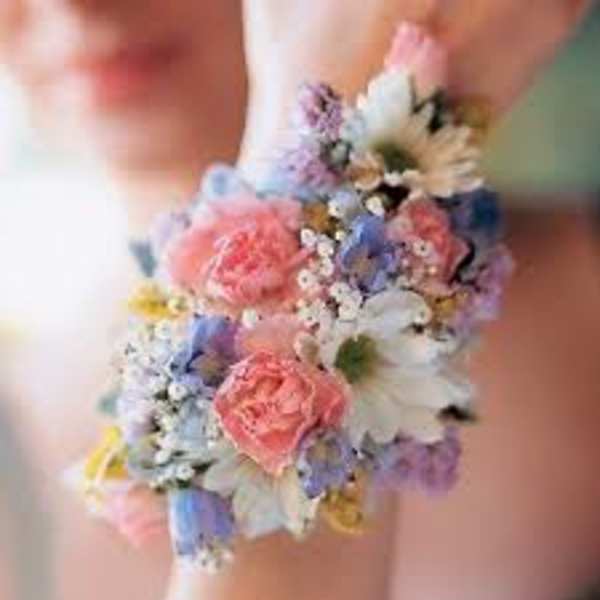 Pastel floral wrist corsage with pink, blue, and white blooms