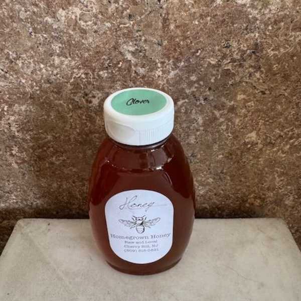 Bottle of honey with a white cap and label