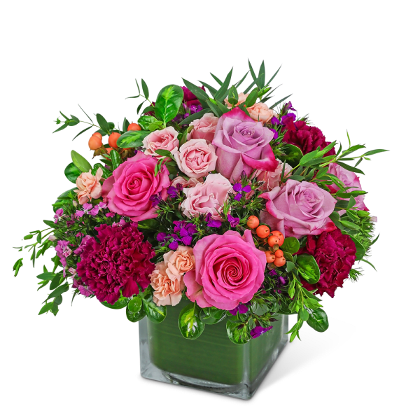 Pink and lavender roses with carnations in a square glass vase