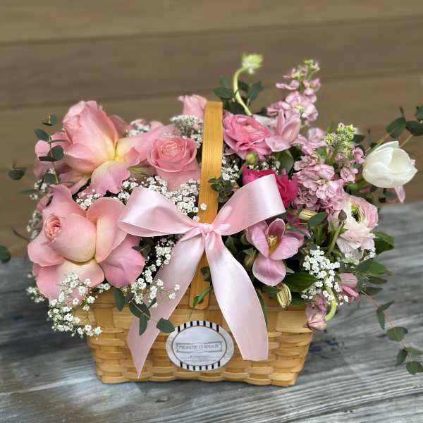 Pink floral basket with roses and a ribbon bow