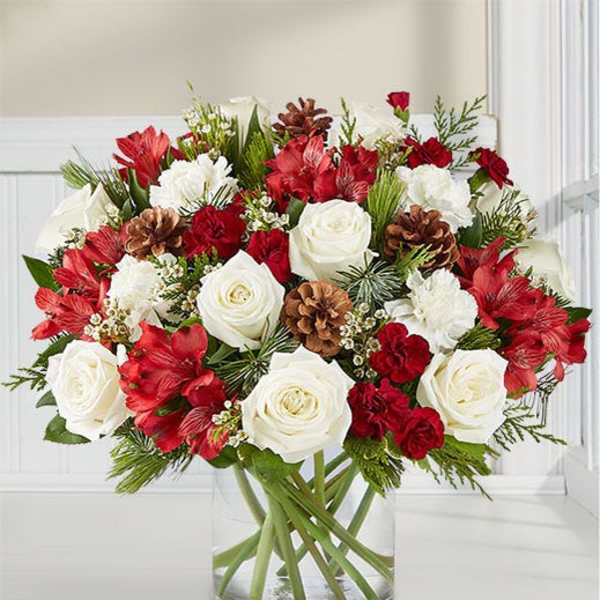 Red and white floral arrangement in a clear glass vase