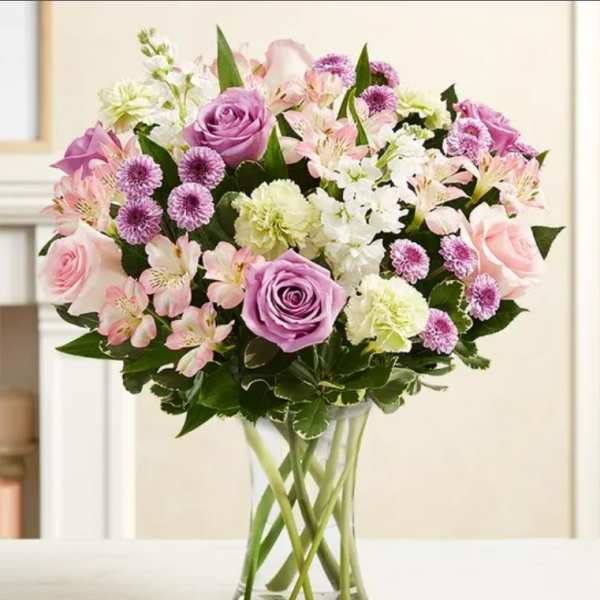 Bouquet of pink and lavender flowers in a clear glass vase