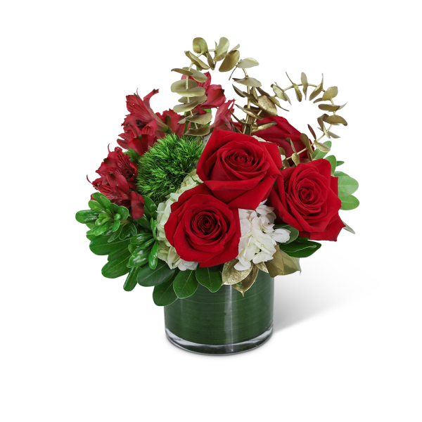 Red roses and white flowers in a glass vase with gold foliage