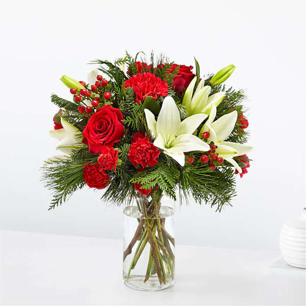 Red roses and white lilies in a clear glass vase