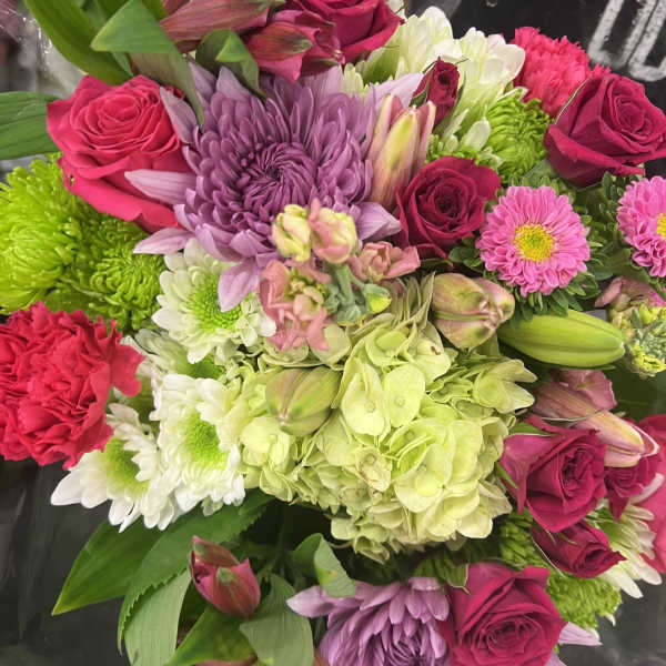Mixed bouquet of pink roses, chrysanthemums, hydrangea, and lilies