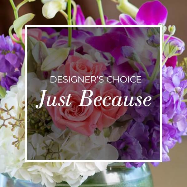 Pink roses and purple orchids in a glass vase with "Just Because" text overlay