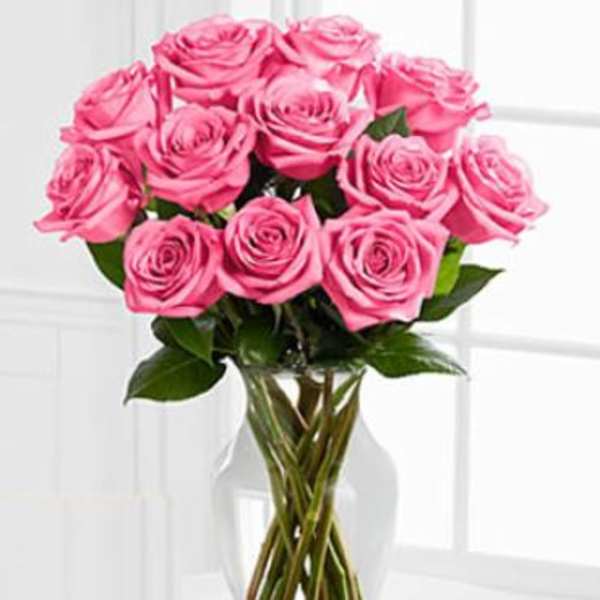 Pink roses arranged in a clear glass vase