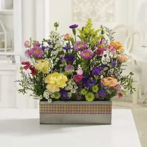 Mixed bouquet in a rectangular box with pink, purple, yellow, and peach flowers