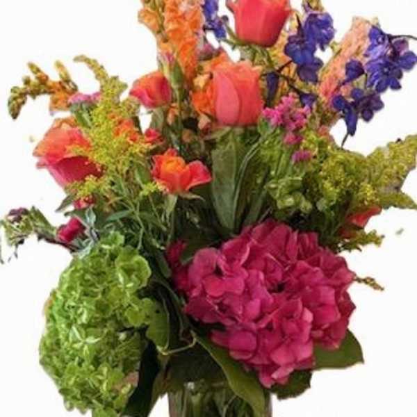 Colorful mixed flower arrangement in a clear glass vase