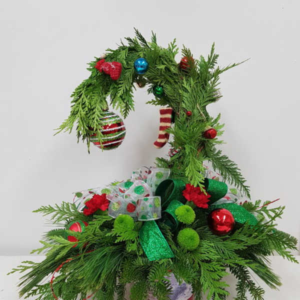 Christmas tree-shaped evergreen arrangement with ornaments and ribbon