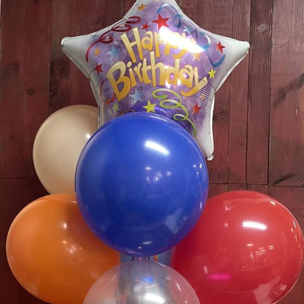 Birthday balloon bouquet with a star-shaped foil balloon and colorful latex balloons