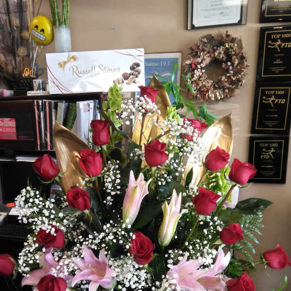 Large bouquet of red roses and pink lilies with baby's breath