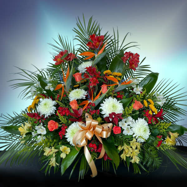 Large tropical floral arrangement with red, white, and orange blooms