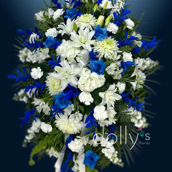 Blue and white funeral spray with lilies and chrysanthemums