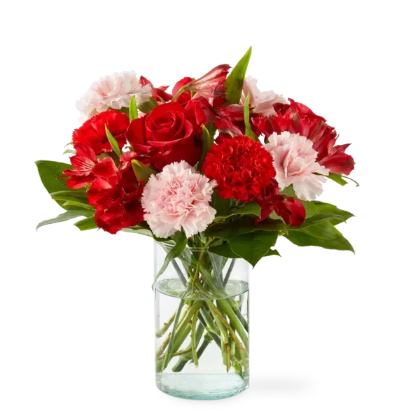 Red roses and pink carnations in a clear glass vase