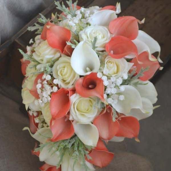 Bouquet of white roses and coral calla lilies