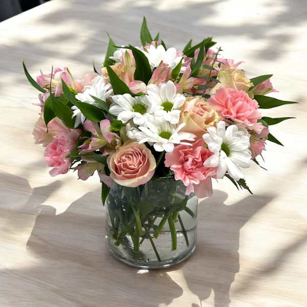 Pink and white mixed bouquet in a clear glass vase