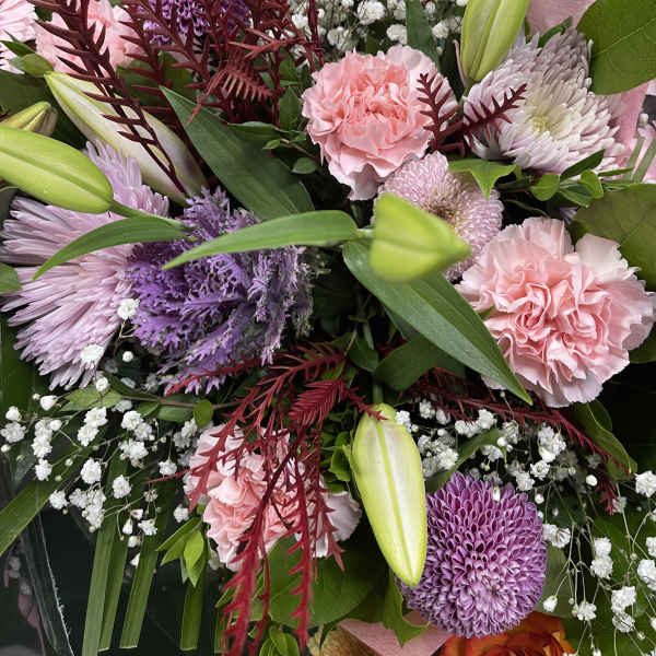 Bouquet of pink and purple flowers with lilies and baby's breath