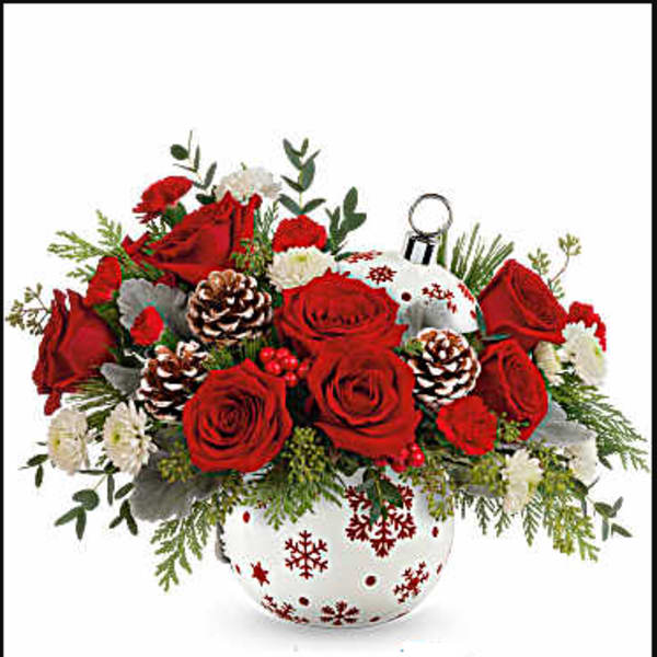 Red roses and white flowers in a snowflake-decorated vase