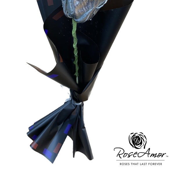 Single metallic silver rose wrapped in black paper