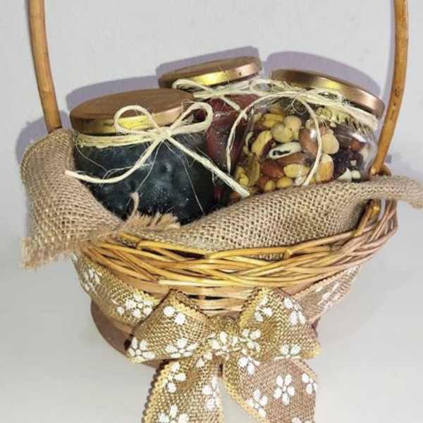 Basket of three lidded jars tied with ribbon