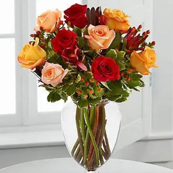 Mixed roses in a clear glass vase