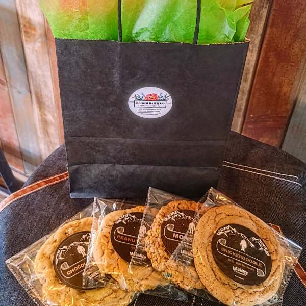 Gift bag with wrapped cookies on a chair