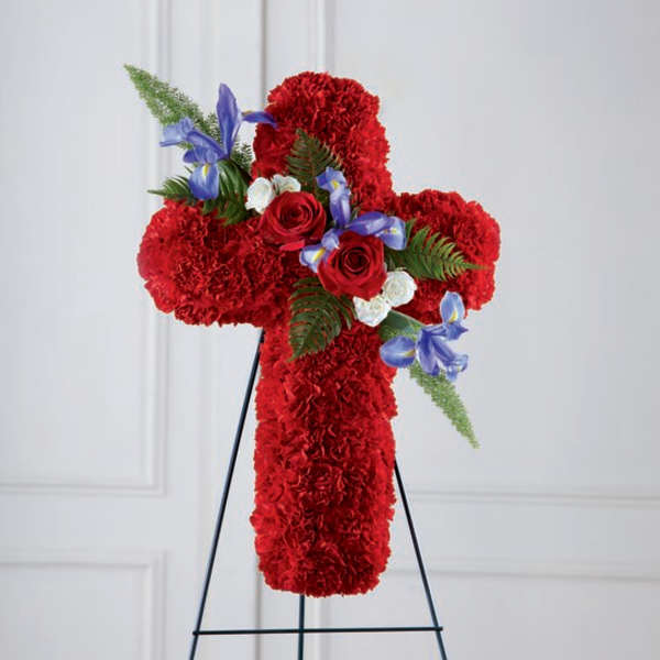 Red floral cross on a black stand with blue accents