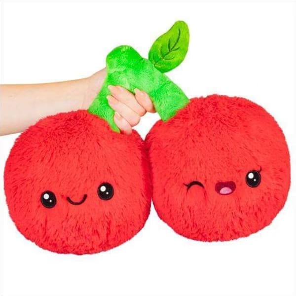 Two red plush cherry toys with smiling faces and a green stem