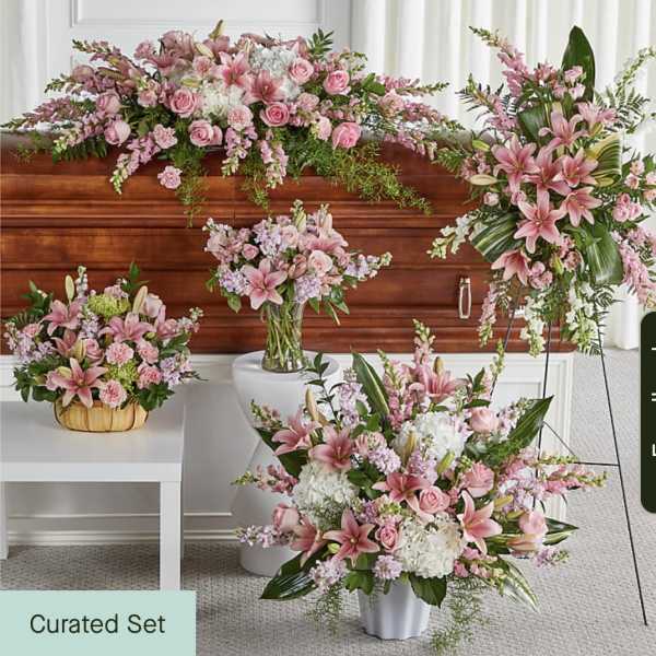 Pink floral funeral set with lilies, roses, and carnations in multiple arrangements