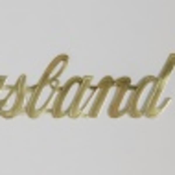 Gold script reading "Husband" on a white background