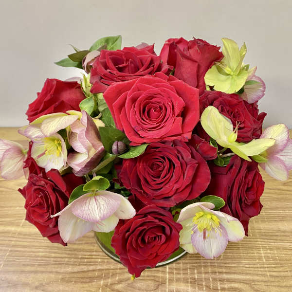 Bouquet of red roses with pale pink and green hellebore blooms