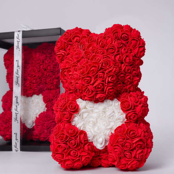 Red rose teddy bear with a white heart in a clear gift box
