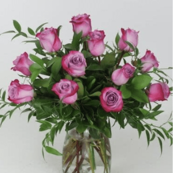 Pink roses arranged in a clear glass vase