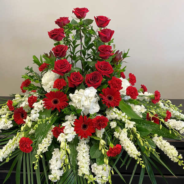 Large red and white floral funeral spray with roses and gerberas