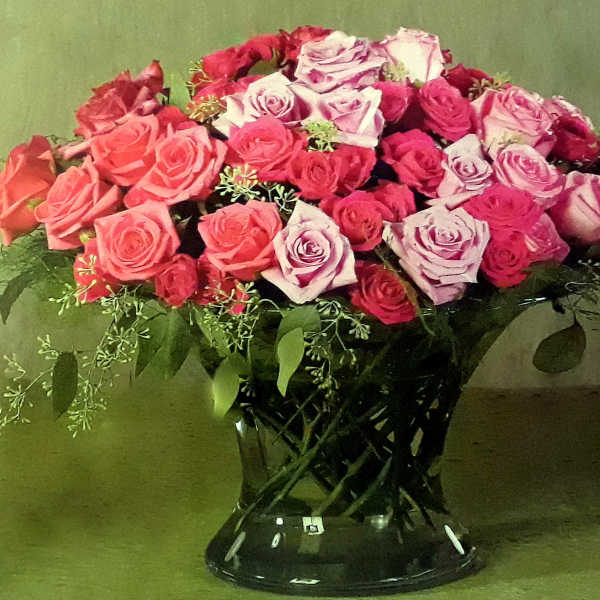 Bouquet of pink and lavender roses in a black vase