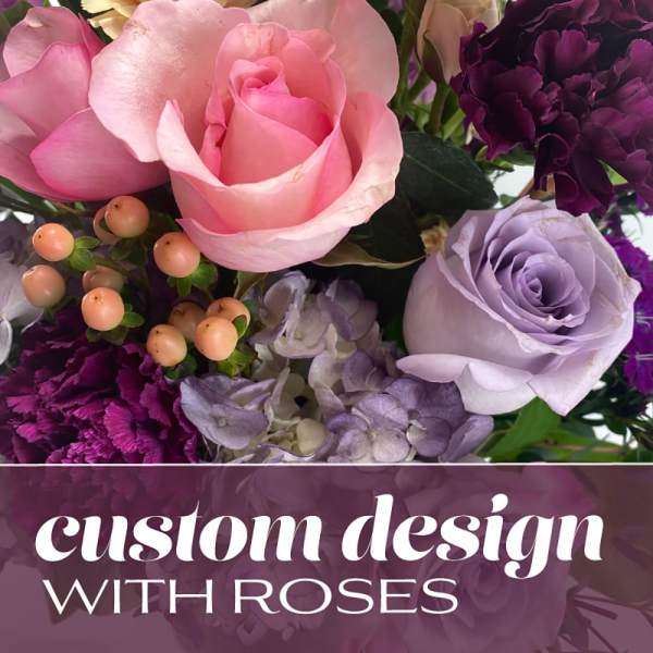 Pink and lavender roses with purple carnations and berries