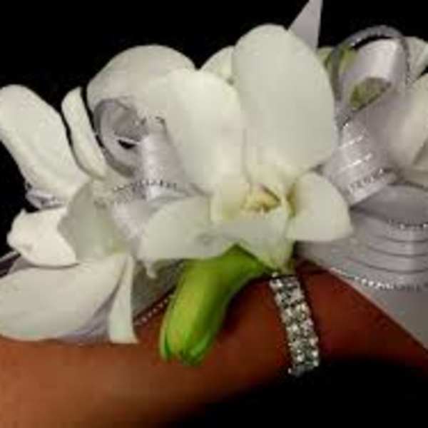 White wrist corsage with ribbon and rhinestone band