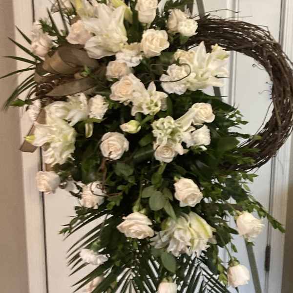Tall white floral standing spray with roses and lilies