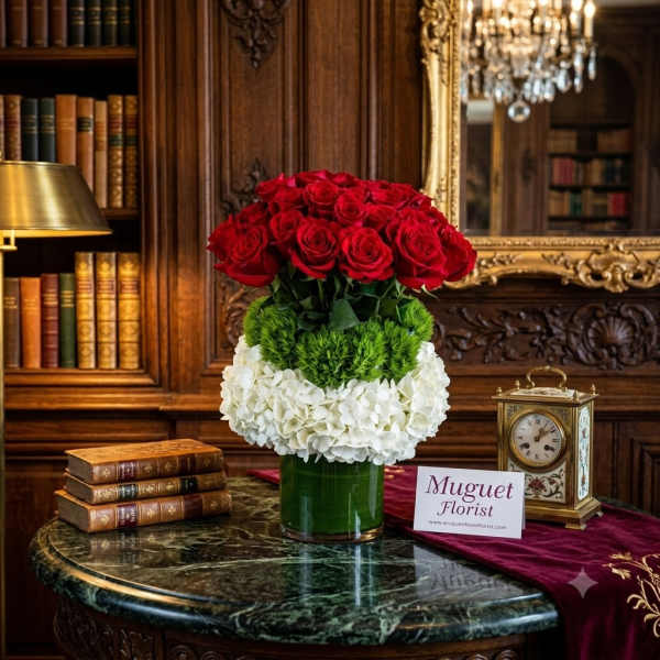 Red roses and white hydrangeas arranged in a glass vase