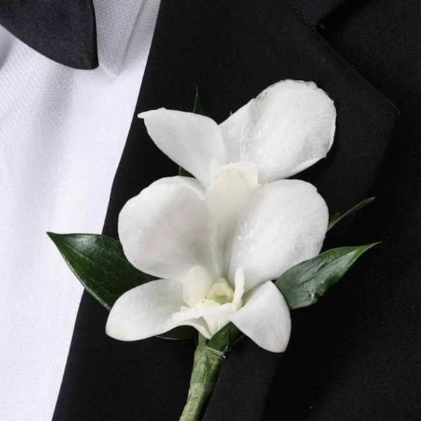 White orchid boutonniere on a black suit jacket
