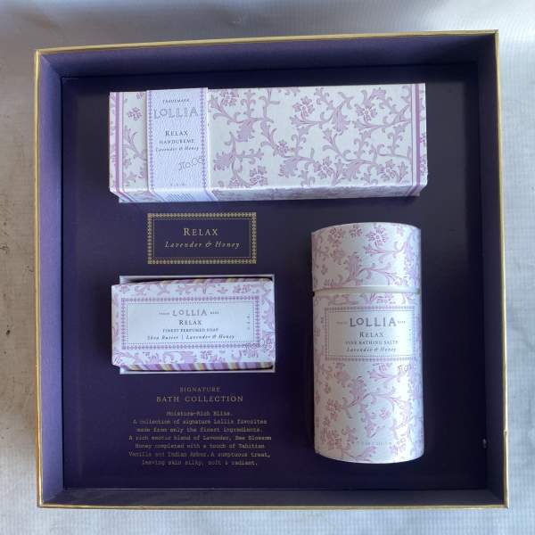 A boxed bath gift set with lavender-patterned soap and bath products.