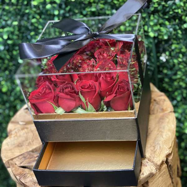 Box of red roses with a black ribbon bow