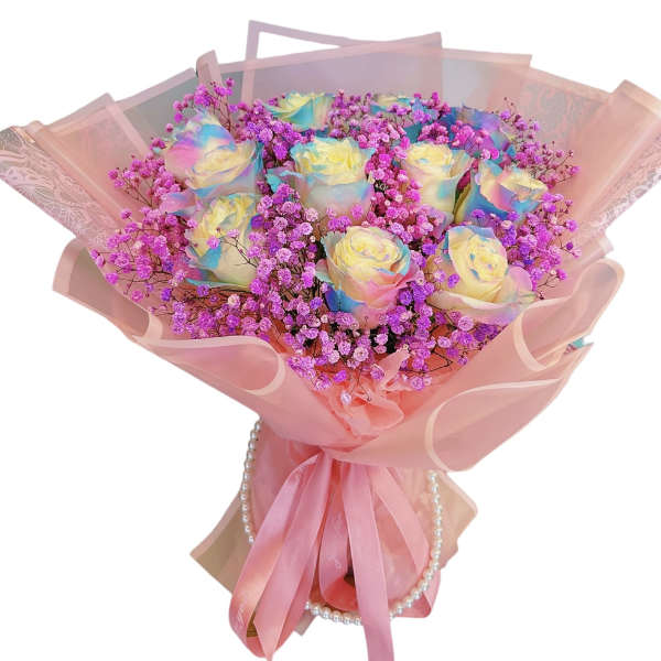 Bouquet of pastel rainbow roses with pink baby's breath in pink wrap